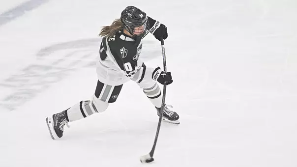 Women's ice hockey player Molly Farace taking a shot during a game