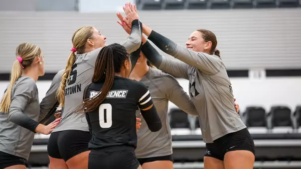 Macy Taylor and Sophia Adkins High-Fiving at Alumni Hall in Providence, R.I. during a non conference match against Brown University