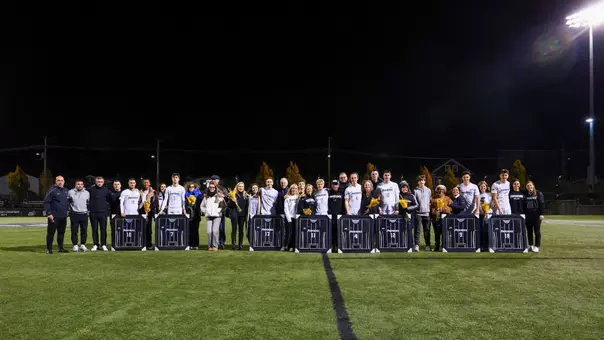 Mens soccer seniors pose with their families during the senior night recognition on Chapey Field at Anderson Stadium.