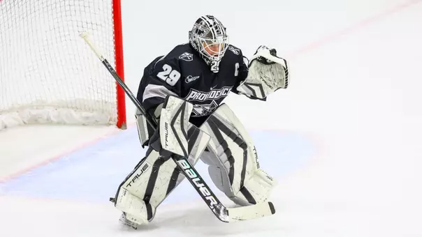 Women's ice hockey goaltender Hope Walinski preparing to make a save during a game
