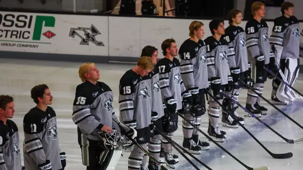 Men's Hockey Team Lines up on blue line pregame.