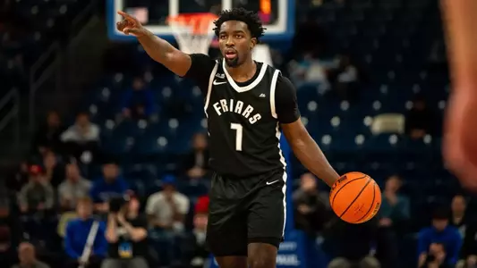 Bensley Joseph before begining an offesnive play points to his team mates as he dribbles ball down the court in game against DePaul at the Amica Mutual Pavilion during the 24-25 season