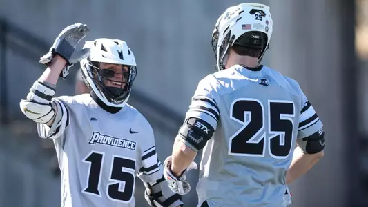 Ryan Bell and Jay Wilkerson high five to celebrate a goal versus Loyola Maryland