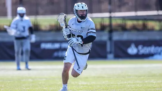 Lacrosse player Albert Paniccia running to clear the ball