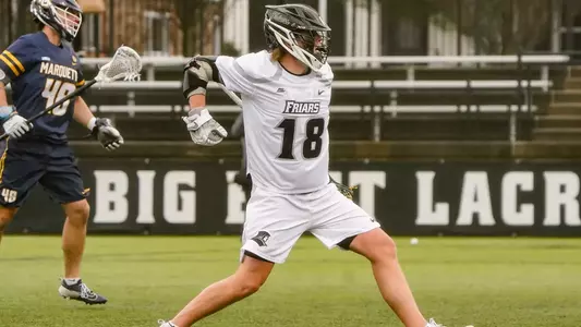 Lacrosse player Jack Horrigan fist pumping after scoring a goal versus Marquette