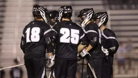 Lacrosse huddle with attack players.