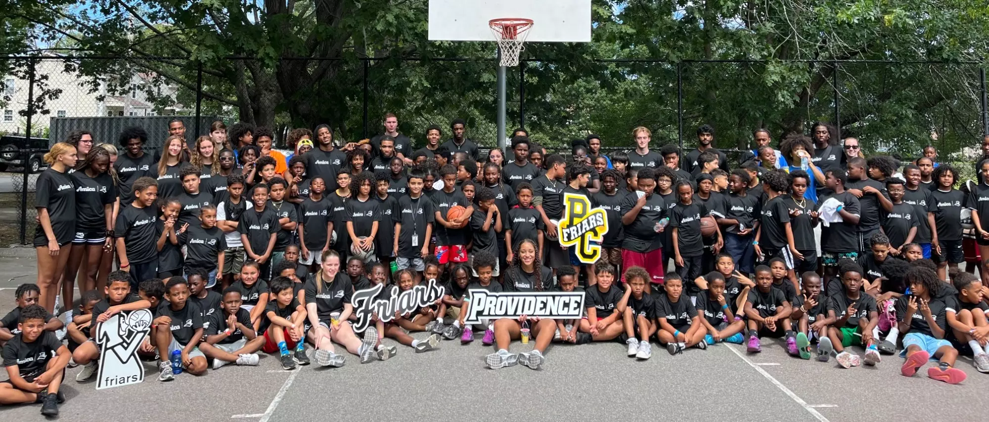 Group shot at the conclusion of the Providence Rec Camp at Corliss Park on July 18, 2025 with PC men's and women's basketball teams.