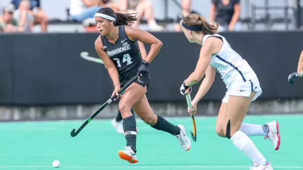 Bo Martina dribbles by a defender during a game against New Hampshire