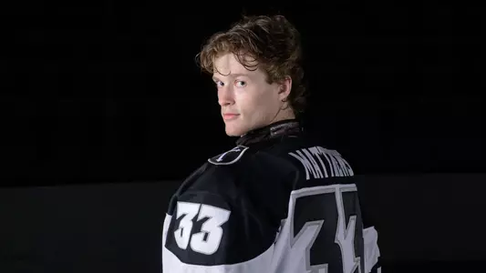 Providence College Men's Hockey player Aaron Matthews poses looking back at the camera during a media day shoot at Schneider Arena in 2025.