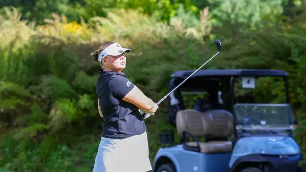 Women's golf player Myla Bisceglia looking at her ball after hitting a tee shot