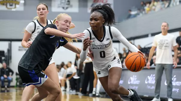 Sabou Gueye dribbles by a Creighton defender toward the basket.