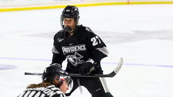 Women's ice hockey player Jessie Pellerin preparing to take a faceoff during a game against Boston College