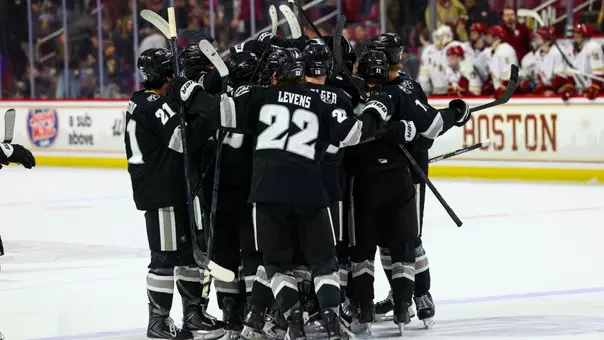 Men's Hockey team celebrates as a group after a win at Boston College