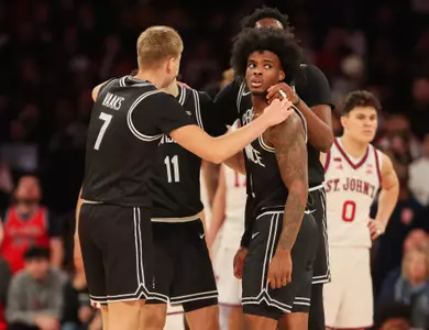 Stefan Vaaks and Jaylin Sellers in a team huddle at St. John's at Madison Square Garden.