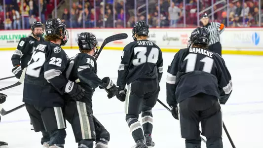 Men's Hockey's Logan Sawyer celebrates an overtime goal