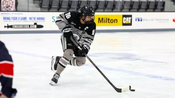 Women's ice hockey player Reichen Kirchmair skating with the puck during a game