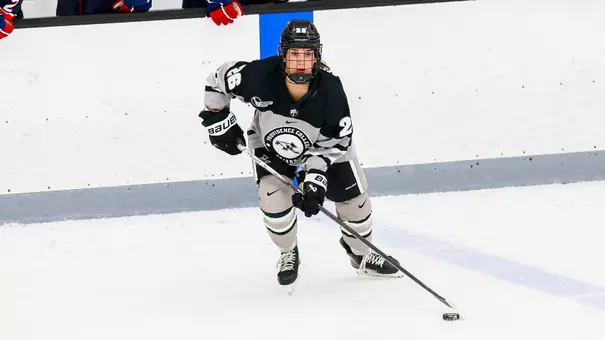 Women's ice hockey player Cristina Cavaliere skating with the puck during a game