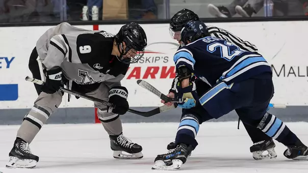 Men's Hockey's Hudson Malinoski takes a faceoff against Maine