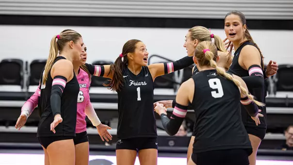 Volleyball celebrating a point against Seton Hall during pink out