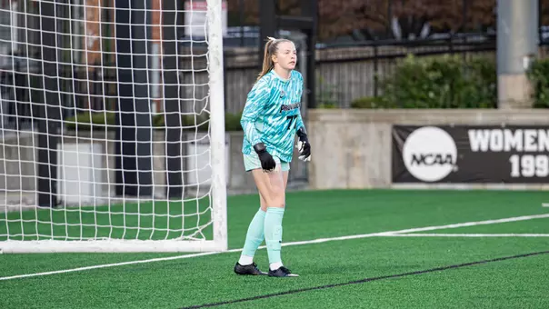 Caitlin Daley walking in the goal box