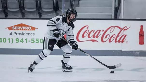 Women's ice hockey player Audrey Knapp skating with the puck
