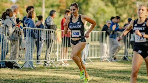 Women's cross country runner Kiera Hall running during a race