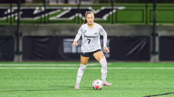 Caitlin Driscoll dribbling the ball on the field vs. St. John's