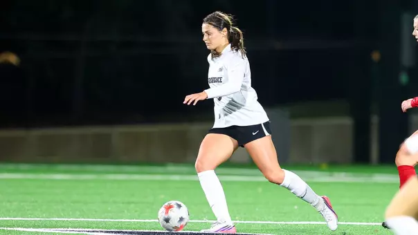Stephanie Schoeley dribbling ball on field vs. St. John's