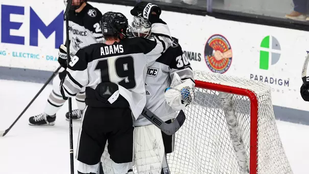 Men's Hockey's Tanner Adams and Jack Parsons celebrate after a win against Boston University