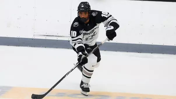 Men's Hockey's Donovan McCoy makes a pass against Boston College