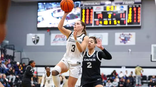 Orlagh Gormley goes up for a one-handed shot surrounded by Xavier defenders
