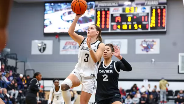 Orlagh Gormley goes up for a one-handed shot surrounded by Xavier defenders