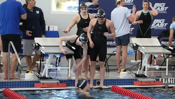 200-Medley Relay Team gathered at the starting block after finishing the race at the BIG EAST Championships on Day one of competition.