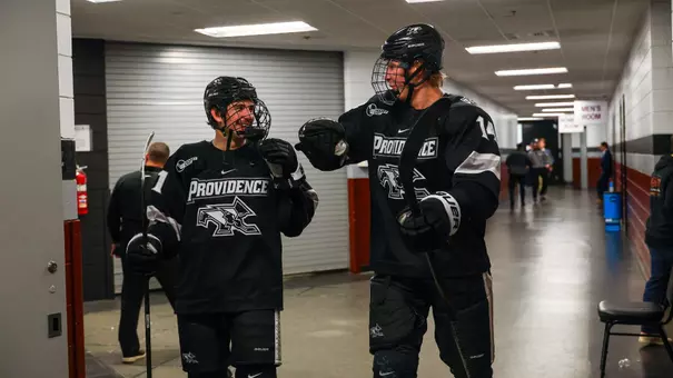 Men's Hockey's Graham Gamache and Aleksi Kivioja celebrate after a win