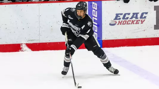 Men's Hockey's Hudson Malinoski skates with the puck against Brown