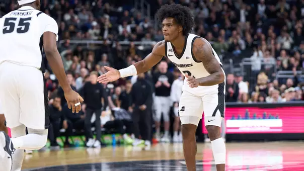 Jaylin Sellers high fives Oswin Erhunmwunse in a Providence College Basketball game.