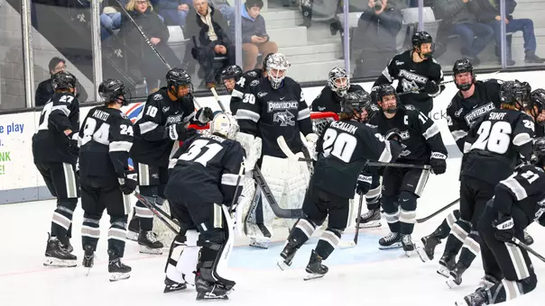 Men's Hockey Team Huddles before a game against UConn