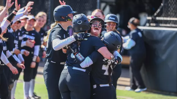 Softball's Emily Jonte, Brianna De La Fuente, Sofia Peterson and Gabriella Lee Celebrating on Glay Field during a non conference game against Stonehill