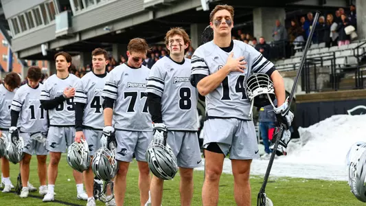 Dean Metzger and Ian Olenik stand for the National Anthem at Chapey Field at Anderson Stadium