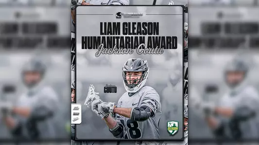 A graphic featuring men's lacrosse player Jackson Coutu wearing a gray uniform with black lettering and a black lacrosse helmet, passing a ball with his stick. The text on the graphic reads: Liam Gleason Humanitarian Award; Jackson Coutu.