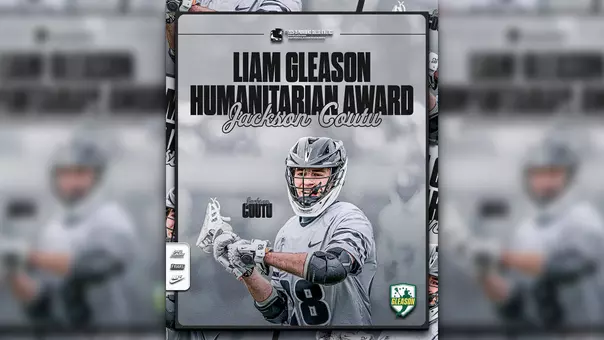 A graphic featuring men's lacrosse player Jackson Coutu wearing a gray uniform with black lettering and a black lacrosse helmet, passing a ball with his stick. The text on the graphic reads: Liam Gleason Humanitarian Award; Jackson Coutu.