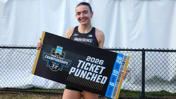 Maeve O'Neill holding a sign that reads "2026 Ticket Punched" on an oversized ticket with the NCAA Division 1 Track and Field Championships logo
