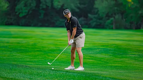 Men's golfer Evan Buddengaen getting ready to hit a golf shot