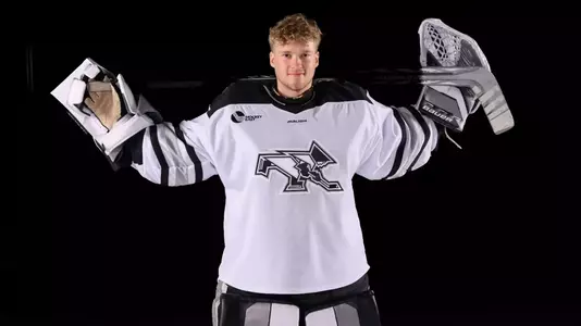 Aaron Matthews Men's Hockey with stick over shoulders