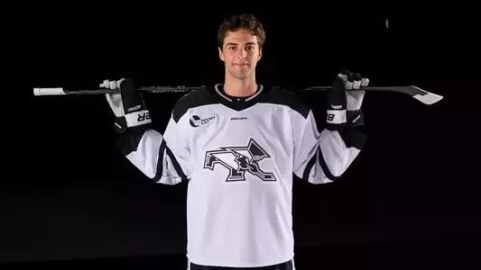 Jack Laferriere Men's Hockey with stick over the shoulders