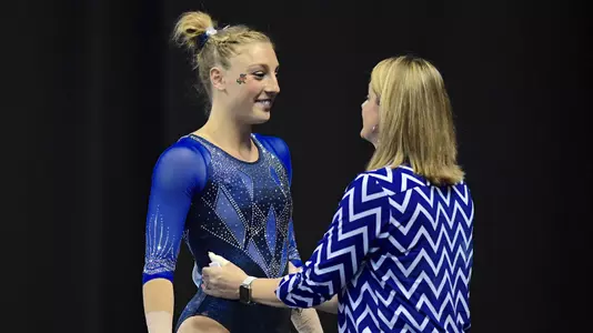 Alex McMurtry speaks with Coach Jenny Rowland before her balance beam routine 4-14-17