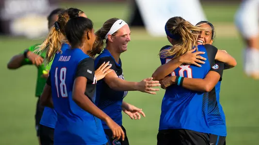 Gabby Seiler is embraced by Briana Solis - vs Stanford 8-25-17