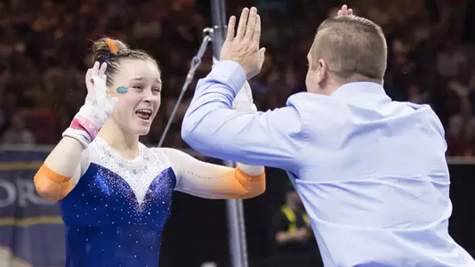 Maegan Chant celebrates her uneven bars routine with Owen Field at 2017 Southeastern Conference Championships