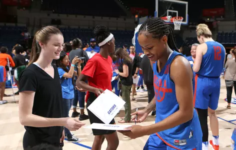Delicia Washington signs an autograph for a fan at Fan Day in 2017.
