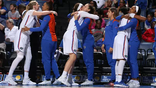 Seniors Paulina Hersler, Haley Lorenzen, Dyandria Anderson bench hugs